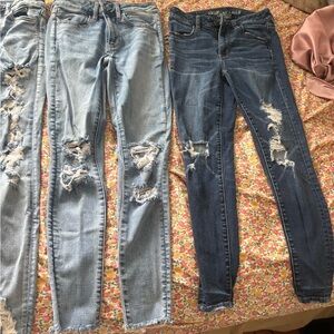 4 pairs of American Eagle Outfitters Light and Dark Blue Distressed Skinny Jeans